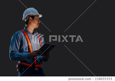Night shift engineer technician male in safety hardhat hand holding tablet at night time isolated with clipping path Night shift engineer technician male in safety hardhat hand holding tablet at night time isolated with clipping path 138035355