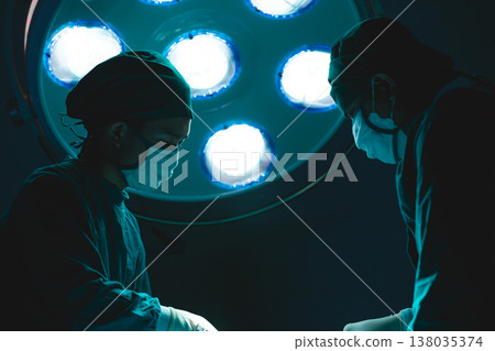 Doctor surgery operating patient in hospital, with Surgical Light Operating Lamp background Doctor surgery operating patient in hospital, with Surgical Light Operating Lamp background 138035374