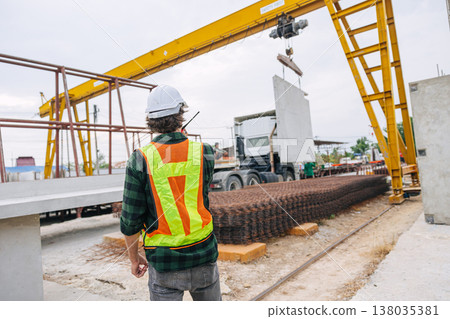 Professional engineer male working in concrete precast plant factory control operate lifting crane in construction site . 138035381