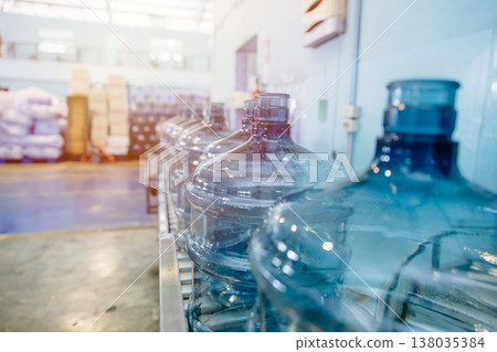drinking water clean gallon bottles at drinking water factory waiting in line for filling in plant. 138035384