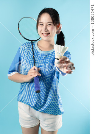 Portrait Badminton player fun action. Asian woman teen with badminton racket and shuttlecock studio. Portrait Badminton player fun action. Asian woman teen with badminton racket and shuttlecock studio. 138035471