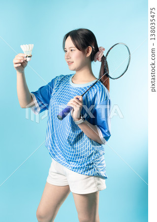 Portrait Badminton player fun action. Asian woman teen with badminton racket and shuttlecock studio. Portrait Badminton player fun action. Asian woman teen with badminton racket and shuttlecock studio. 138035475