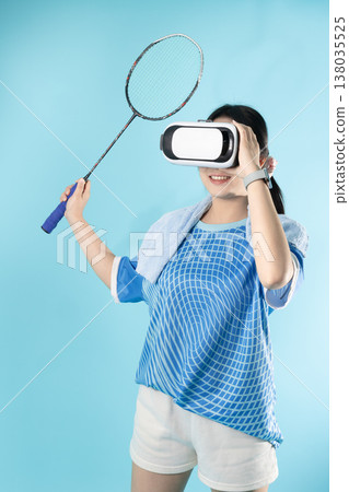 Happy smiling woman teen girl with badminton VR game playing studio shot enjoy sport game play Happy smiling woman teen girl with badminton VR game playing studio shot enjoy sport game play 138035525
