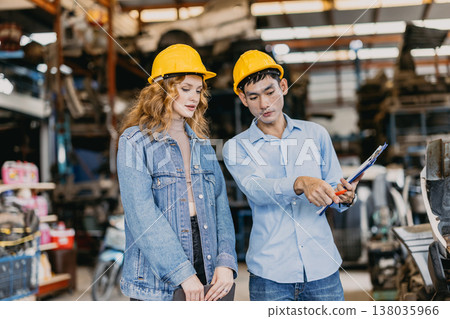 Technician male worker working in garage scrap yard old car part workshop warehouse 138035966