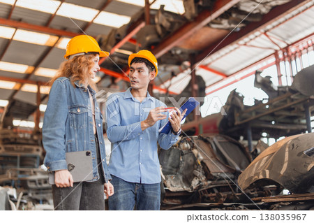 Technician male worker working in garage scrap yard old car part workshop warehouse 138035967