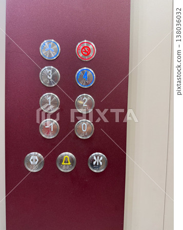 Elevator control panel with illuminated floor buttons and accessibility markings inside a modern building. Vertical transport, navigation, user interface, assisted mobility, and interior wayfinding in 138036032