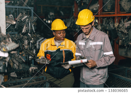 African women with engineer man staff worker working heavy industry old part warehouse African women with engineer man staff worker working heavy industry old part warehouse 138036085