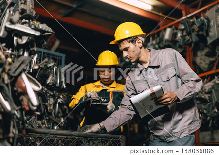 African women with engineer man staff worker working heavy industry old part warehouse African women with engineer man staff worker working heavy industry old part warehouse 138036086