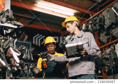 African women with engineer man staff worker working heavy industry old part warehouse African women with engineer man staff worker working heavy industry old part warehouse 138036087