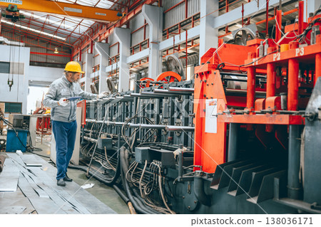 Professional senior Industrial worker in protective helmet and uniform service machinery in factory Professional senior Industrial worker in protective helmet and uniform service machinery in factory 138036171