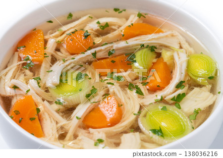 Homemade chicken soup in white bowl with carrots and celery Homemade chicken soup in white bowl with carrots and celery 138036216