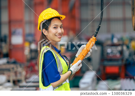 Young Asian woman engineer worker happy smiling professional working in heavy industry plant factory 138036329