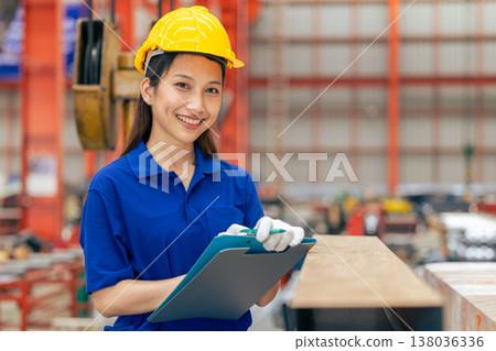 Young Asian woman engineer worker happy smiling professional working in metal sheet plant factory Young Asian woman engineer worker happy smiling professional working in metal sheet plant factory 138036336