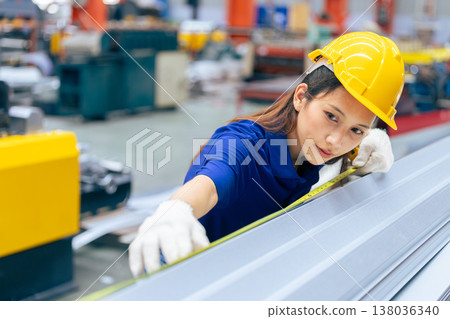 Young Asian woman engineer worker measuring product size, professional work in metal sheet factory Young Asian woman engineer worker measuring product size, professional work in metal sheet factory 138036340