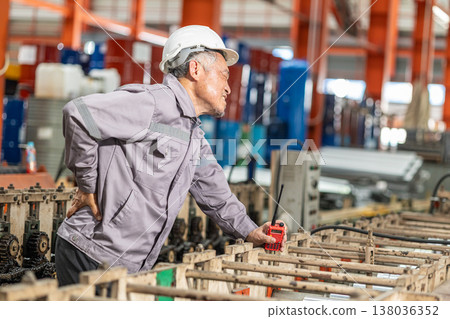 Senior Asian worker muscle pain, Suffer from back pain, health problem at work Senior Asian worker muscle pain, Suffer from back pain, health problem at work 138036352