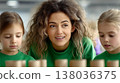 Teacher helping two caucasian children learning with wooden blocks in preschool classroom during educational activity 138036375