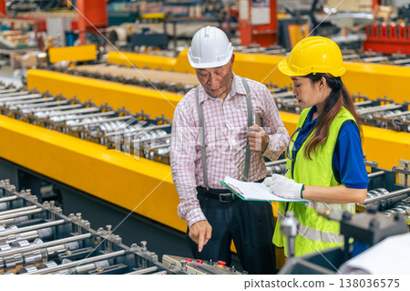women worker working in plant factory with senior supervisor training checking work order women worker working in plant factory with senior supervisor training checking work order 138036575