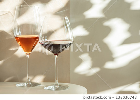 Rose and Red Wine Glasses under Sunlight. Elegant Spring Still Life Rose and Red Wine Glasses under Sunlight. Elegant Spring Still Life 138036748