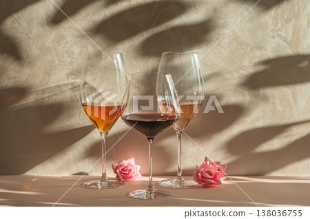 Three Wine Glasses with Rose, White and Red Wine. Romantic Still Life with Warm Light. Three Wine Glasses with Rose, White and Red Wine. Romantic Still Life with Warm Light. 138036755