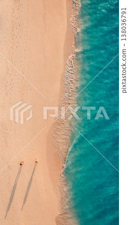 Top-down aerial view of couple walking on sandy beach, warm sunlight casting shadows, idyllic outdoors, carefree summer holiday travel background Top-down aerial view of couple walking on sandy beach, warm sunlight casting shadows, idyllic outdoors, carefree summer holiday travel background 138036791