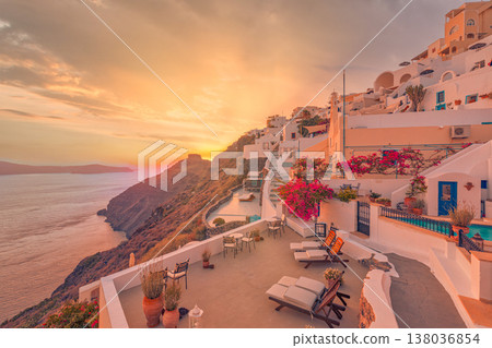 Sunset over Santorini Greece caldera, sun beds and flowers, idyllic romance, honeymoon couple, love travel destination, tourism background Sunset over Santorini Greece caldera, sun beds and flowers, idyllic romance, honeymoon couple, love travel destination, tourism background 138036854
