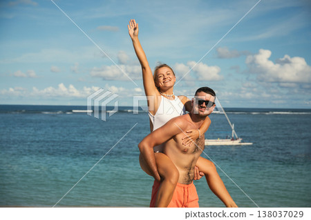 Couple enjoying fun and laughter on a sunny beach day Couple enjoying fun and laughter on a sunny beach day 138037029