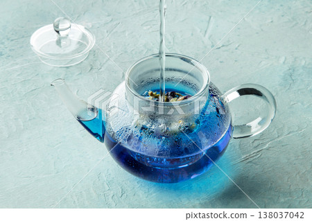 Blue tea, an infusion of butterfly pea flowers, hot water being poured 138037042