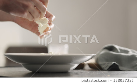 add mozzarella cheese to pasta into plate closeup 138037355