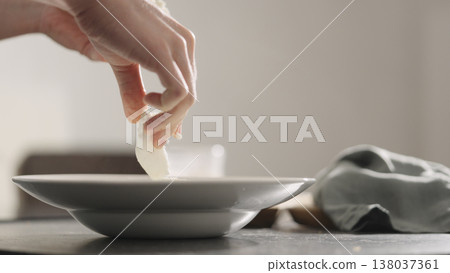 add mozzarella cheese to pasta into plate closeup add mozzarella cheese to pasta into plate closeup 138037361