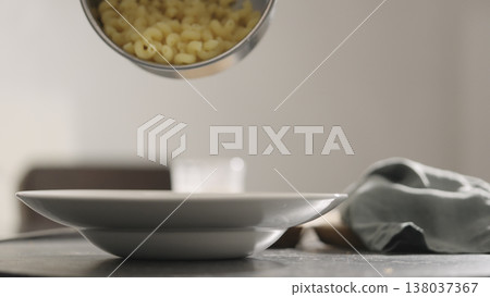 cooked cellentani pasta fall into plate closeup cooked cellentani pasta fall into plate closeup 138037367