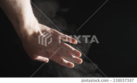 man hand touching steam rising from boiling water over black background man hand touching steam rising from boiling water over black background 138037387