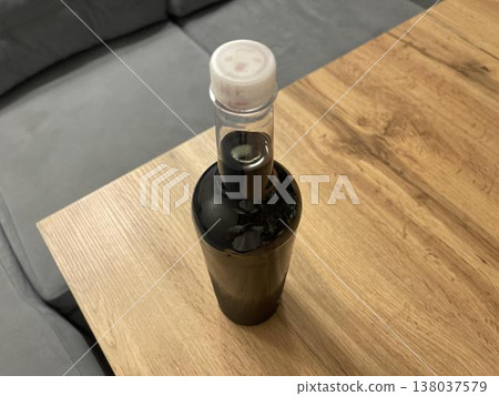 wine bottle isolated on wooden table wine bottle isolated on wooden table 138037579