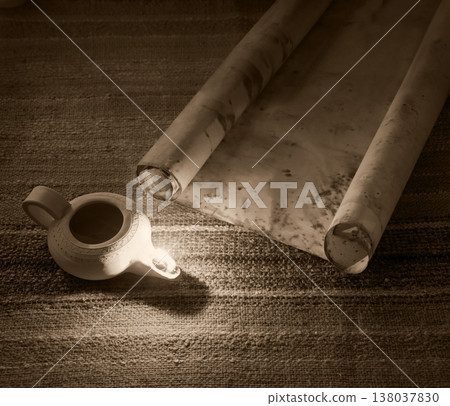 Old oil lamp and scroll Old oil lamp and scroll 138037830