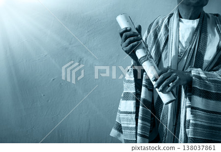 Male hand holding an old scroll 138037861