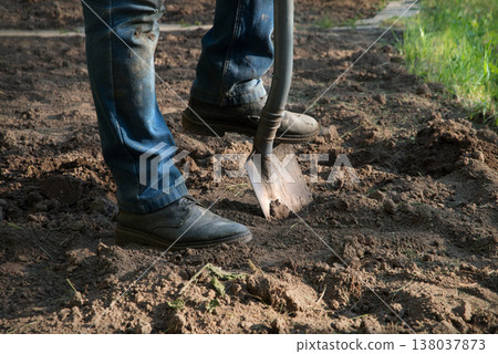 Man's feet with a shovel Man's feet with a shovel 138037873