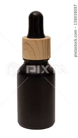 This cut out object shows a small black bottle with a wooden dropper. It is designed for storing essential oils or other liquids. The background is clear and simple 138038097