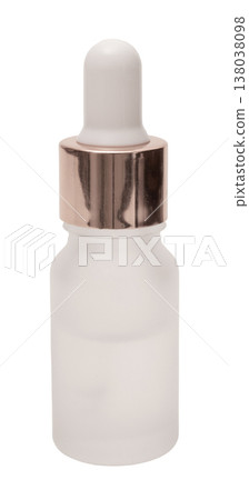A clear glass dropper bottle with a white dropper top and a metal cap is isolated on a plain white background. This bottle can hold serums or liquids for cosmetic use 138038098