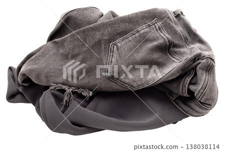 A pile of clothes sits on a clear background. The items include a pair of faded jeans and a gray sweatshirt. The fabric looks soft and well-used A pile of clothes sits on a clear background. The items include a pair of faded jeans and a gray sweatshirt. The fabric looks soft and well-used 138038114