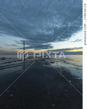 Road leading to the sea and utility poles Road leading to the sea and utility poles 138038118