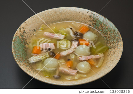 A beautiful consommé soup featuring sweet, small pearl onions and colorful carrots. A beautiful consommé soup featuring sweet, small pearl onions and colorful carrots. 138038256