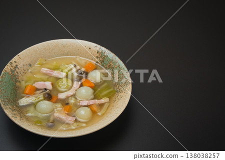 A beautiful consommé soup featuring sweet, small pearl onions and colorful carrots. A beautiful consommé soup featuring sweet, small pearl onions and colorful carrots. 138038257