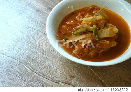 boiled mixed vegetable in spicy and sour orange curry soup on bowl 138038592