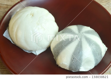 Chinese steamed bun stuffed sweet mashed red bean and salty chop pork on plate Chinese steamed bun stuffed sweet mashed red bean and salty chop pork on plate 138038621