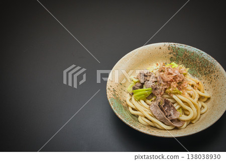Our family's go-to dish: stir-fried udon noodles, seasoned with soy sauce and topped with bonito flakes. 138038930