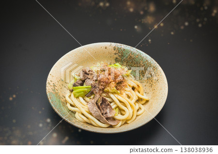 Our family's go-to dish: stir-fried udon noodles, seasoned with soy sauce and topped with bonito flakes. 138038936