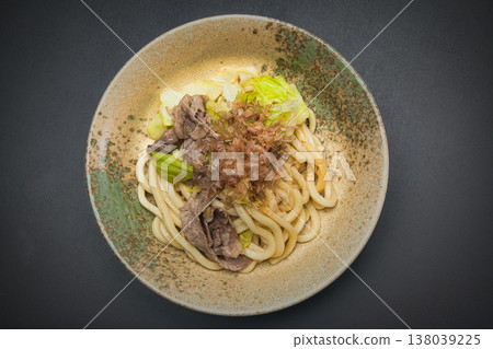 Our family's go-to dish: stir-fried udon noodles, seasoned with soy sauce and topped with bonito flakes. 138039225