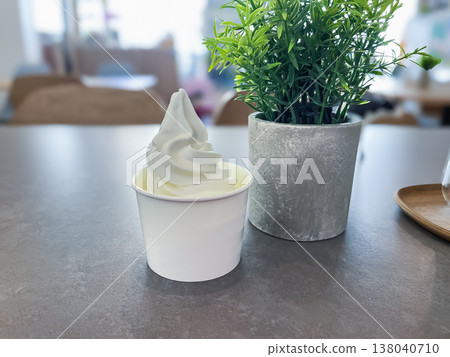 Cup soft serve. Cold soft serve ice cream served in a cup. 138040710