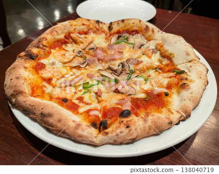 A pizza topped with tomato sauce, cheese, bacon, and mushrooms. A pizza topped with tomato sauce, cheese, bacon, and mushrooms. 138040719