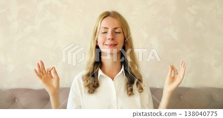 Calm relaxed healthy young woman meditates, girl practicing doing yoga exercises, stress relief Calm relaxed healthy young woman meditates, girl practicing doing yoga exercises, stress relief 138040775
