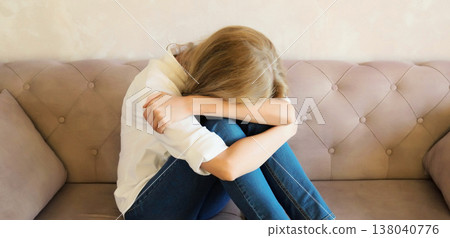 Sad crying woman while experiencing mental suffering, depression, fatigue, emotional stress 138040776